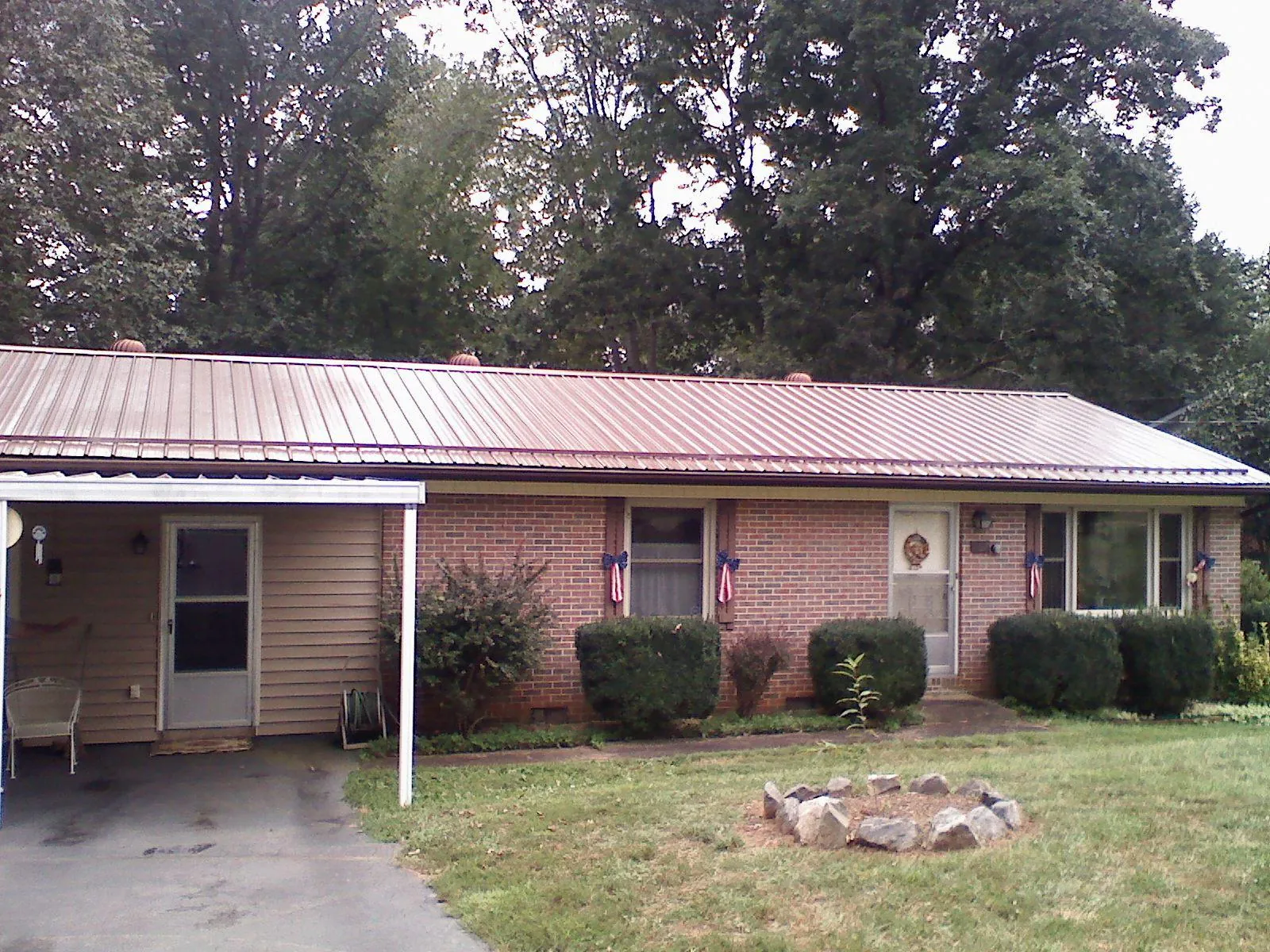 Bronze metal roof and carport on a brick ranch home — Roof Repair work by our crew in Elizabethville
